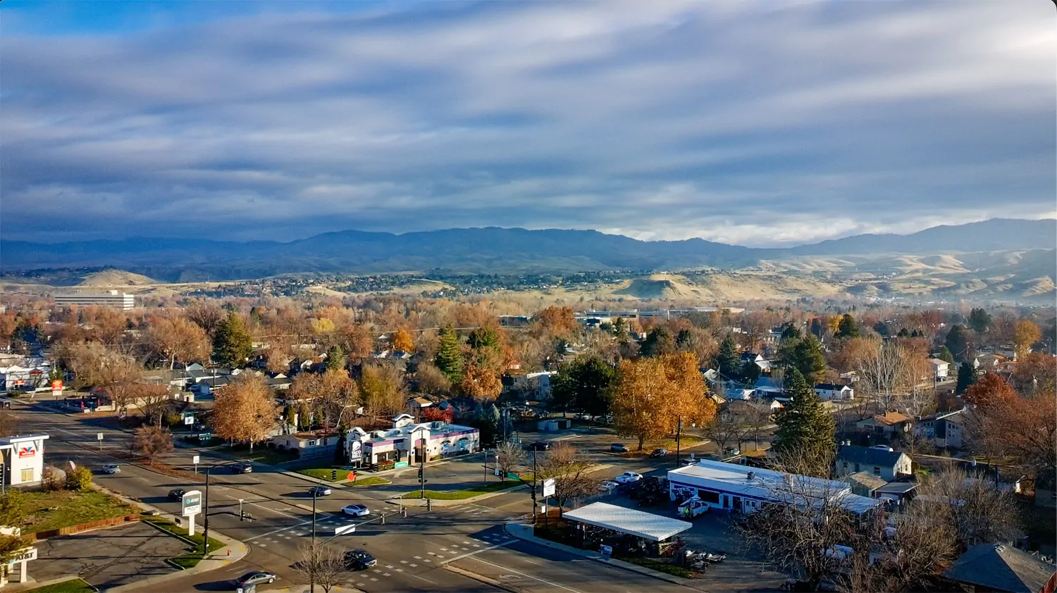 A Boise neighborhood and intersection sit beneath the foothills, showing how the city’s built environment and surrounding landscape work together to orient people in place.