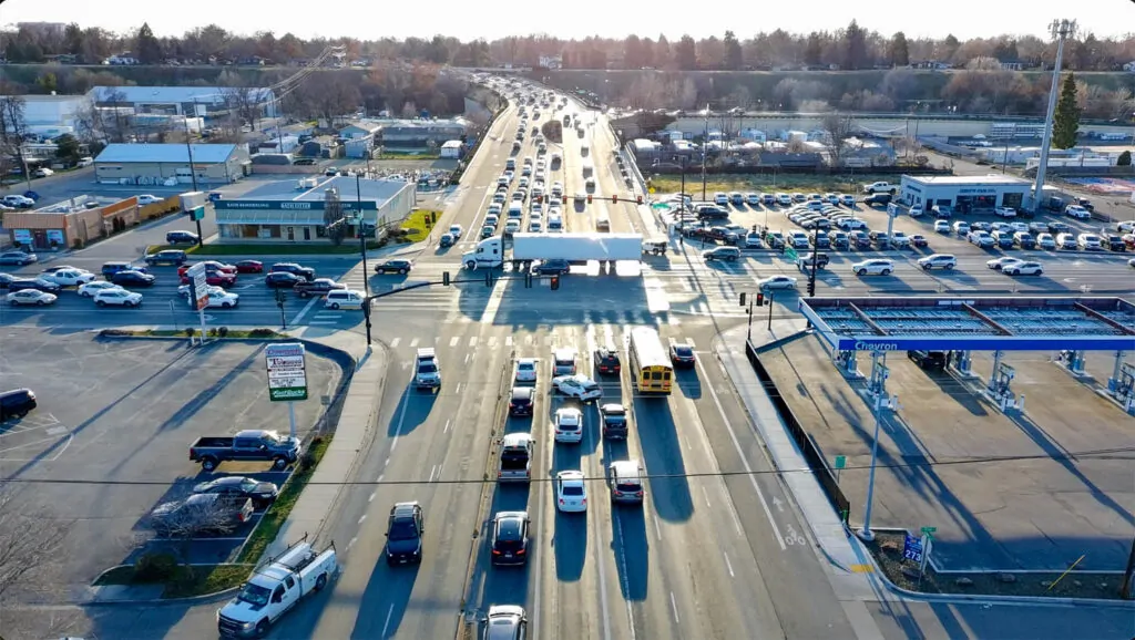 A major Boise traffic corridor lined with parking lots and commercial uses illustrates growth built for speed rather than rooted place.