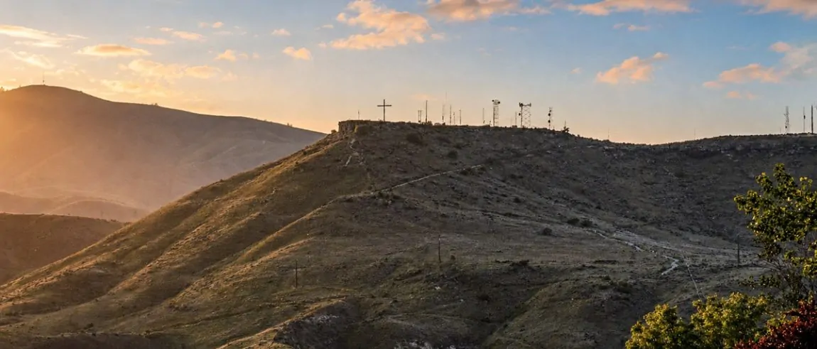 Table Rock in Boise at sunset, with the summit cross and communication towers visible along the ridge.